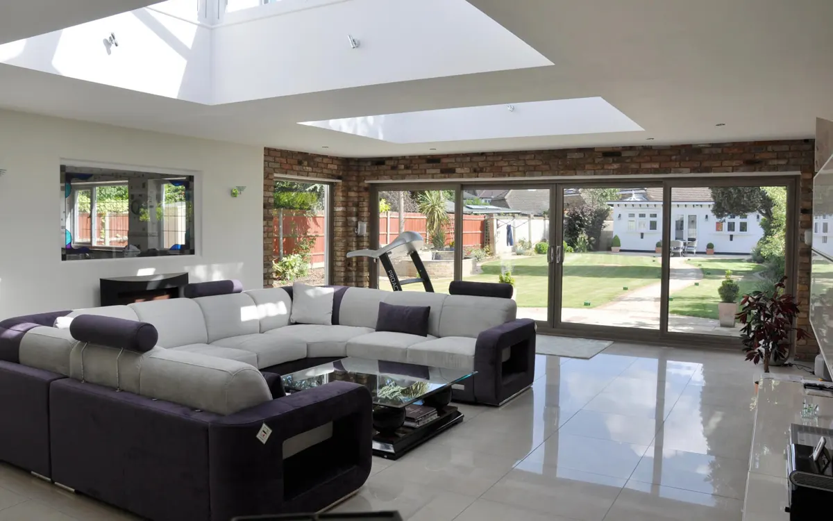 Open-plan living room with full-width sliding patio doors fitted by IB Windows